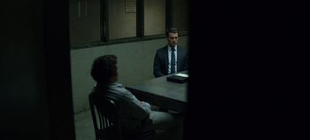 Movie still from “Mindhunter” (2017), directed by Tobias Lindholm – Two men sitting at a table in front of each other; Wide shot, Over the shoulder angle