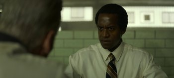 Movie still from “Mindhunter” (2017), directed by Tobias Lindholm – A man wearing a white dress shirt and a tie; Close Up shot, Over the shoulder angle