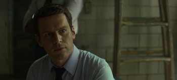 Movie still from “Mindhunter” (2017), directed by Tobias Lindholm – A person wearing a shirt and a tie; Close Up shot, Over the shoulder angle