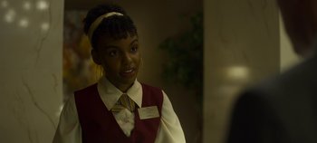 Movie still from “Mindhunter” (2017), directed by Tobias Lindholm – A woman wearing a red vest and a yellow tie; Close Up shot, Over the shoulder angle