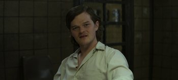 Movie still from “Mindhunter” (2017), directed by Tobias Lindholm – A man with long brown hair wearing a white shirt; Close Up shot, Over the shoulder angle