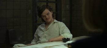 Movie still from “Mindhunter” (2017), directed by Tobias Lindholm – A man sitting at a table in front of a window; Medium shot, Over the shoulder angle