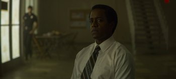 Movie still from “Mindhunter” (2017), directed by Tobias Lindholm – A man wearing a white dress shirt and a tie; Close Up shot, Low angle