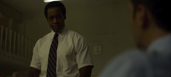 Movie still from “Mindhunter” (2017), directed by Tobias Lindholm – A man wearing a white dress shirt and a tie; Close Up shot, Over the shoulder angle