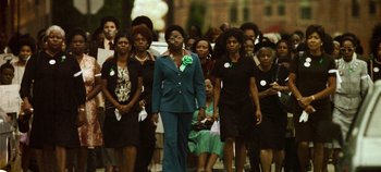 Movie still from “Mindhunter” (2017), directed by Tobias Lindholm – A group of people walking down a street; Wide shot, High angle