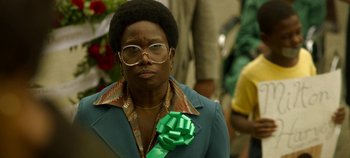 Movie still from “Mindhunter” (2017), directed by Tobias Lindholm – An older woman wearing glasses and a green bow tie; Close Up shot, Low angle