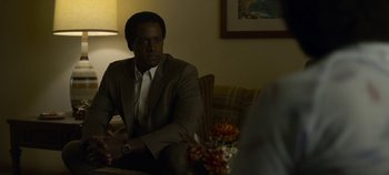 Movie still from “Mindhunter” (2017), directed by Tobias Lindholm – A man sitting on a couch in front of another man; Medium shot, Over the shoulder angle