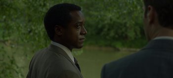 Movie still from “Mindhunter” (2017), directed by Tobias Lindholm – A man wearing a suit and tie looking to his left; Close Up shot, Over the shoulder angle