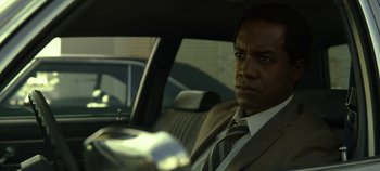 Movie still from “Mindhunter” (2017), directed by Tobias Lindholm – A man sitting in the back seat of a car; Close Up shot, Low angle