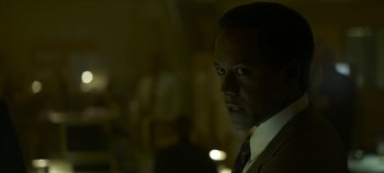 Movie still from “Mindhunter” (2017), directed by Tobias Lindholm – A person wearing a suit and tie; Close Up shot, Over the shoulder angle
