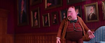 Movie still from “Missing Link” (2019), directed by Chris Butler – A doll of a man in a suit and bow tie in front of a wall of pictures; Medium shot, Low angle