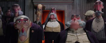 Movie still from “Missing Link” (2019), directed by Chris Butler – A group of cartoon characters standing next to each other in front of a fire place; Medium shot, Low angle