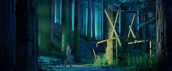 Movie still from “Missing Link” (2019), directed by Chris Butler – A man standing in a forest with a sword; Extreme Wide shot, Low angle