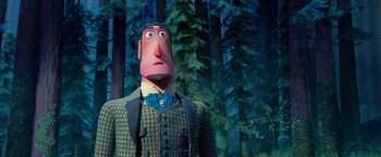 Movie still from “Missing Link” (2019), directed by Chris Butler – A statue of a man in a suit and tie with trees in the background; Close Up shot, Low angle
