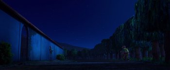 Movie still from “Missing Link” (2019), directed by Chris Butler – A person standing in front of a barn at night; Extreme Wide shot, Low angle