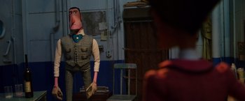 Movie still from “Missing Link” (2019), directed by Chris Butler – A man with a fake nose and mouth standing next to a chair; Medium shot, Over the shoulder angle