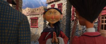 Movie still from “Missing Link” (2019), directed by Chris Butler – A statue of a woman in a red jacket; Close Up shot, Low angle