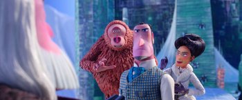 Movie still from “Missing Link” (2019), directed by Chris Butler – A monkey and a man are standing next to each other; Medium shot, Low angle