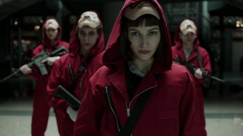 Movie still from “Money Heist” (2017), created by Álex Pina – A group of young people in red jackets and helmets; Close Up shot, Low angle