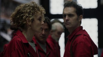 Movie still from “Money Heist” (2017), created by Álex Pina – A group of people in red jackets standing next to each other; Close Up shot, Over the shoulder angle