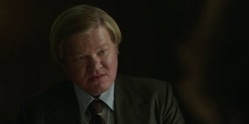 Movie still from “Love & Death” (2023), directed by Clark Johnson – A person wearing a suit and tie; Close Up shot, Low angle