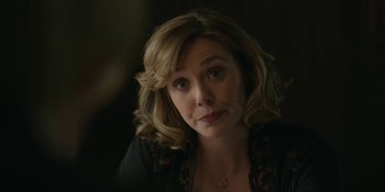 Movie still from “Love & Death” (2023), directed by Clark Johnson – A person wearing a black shirt; Close Up shot, Over the shoulder angle