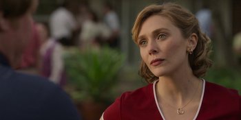 Movie still from “Love & Death” (2023), directed by Clark Johnson – A person wearing a red shirt; Close Up shot, Over the shoulder angle