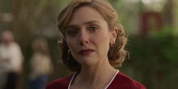 Movie still from “Love & Death” (2023), directed by Clark Johnson – A person wearing a red shirt; Close Up shot, Over the shoulder angle