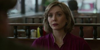 Movie still from “Love & Death” (2023), directed by Clark Johnson – A person sitting in a room; Close Up shot, Over the shoulder angle