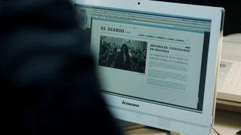 Movie still from “Money Heist” (2017), created by Álex Pina – A computer screen with a person sitting in front of it; Extreme Close Up shot, Over the shoulder angle