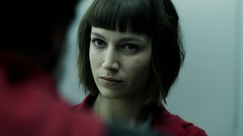 Movie still from “Money Heist” (2017), created by Álex Pina – A person wearing a red jacket; Close Up shot, Over the shoulder angle