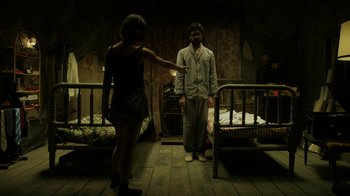 Movie still from “Money Heist” (2017), created by Álex Pina – A man and a woman standing next to each other in a room; Wide shot, Over the shoulder angle