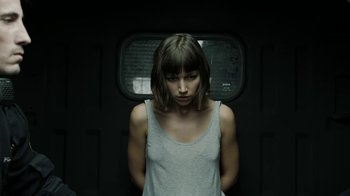 Movie still from “Money Heist” (2017), created by Álex Pina – A woman standing in front of a window; Medium shot, Low angle