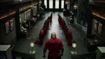 Movie still from “Money Heist” (2017), created by Álex Pina – A group of people sitting in a room; Wide shot, High angle