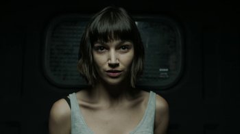 Movie still from “Money Heist” (2017), created by Álex Pina – A person with short brown hair; Close Up shot, Low angle