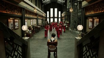 Movie still from “Money Heist” (2017), created by Álex Pina – A group of women in red outfits in a room; Extreme Wide shot, High angle