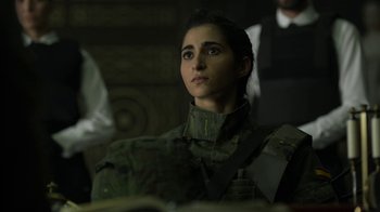 Movie still from “Money Heist” (2017), created by Álex Pina – A woman in a uniform looking up at something; Close Up shot, Over the shoulder angle