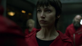 Movie still from “Money Heist” (2017), created by Álex Pina – A person wearing a red jacket; Close Up shot, Low angle