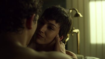Movie still from “Money Heist” (2017), created by Álex Pina – A man and a woman are looking at one another in the mirror; Close Up shot, Over the shoulder angle