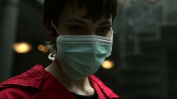 Movie still from “Money Heist” (2017), created by Álex Pina – A person wearing a face mask in the dark; Close Up shot, Low angle