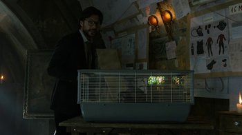 Movie still from “Money Heist” (2017), created by Álex Pina – A man standing in front of a bird cage; Close Up shot, Over the shoulder angle