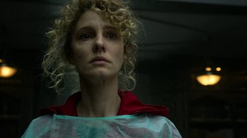 Movie still from “Money Heist” (2017), created by Álex Pina – A person with curly blonde hair; Close Up shot, Low angle