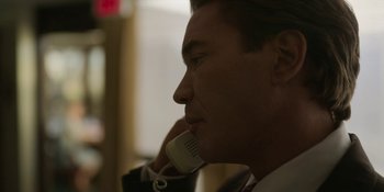 Movie still from “Love & Death” (2023), directed by Clark Johnson – A person talking on a phone; Close Up shot, Over the shoulder angle