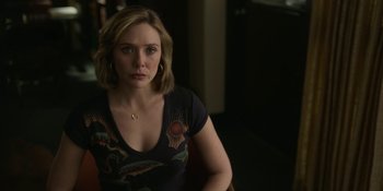 Movie still from “Love & Death” (2023), directed by Clark Johnson – A woman in a black shirt is looking at the camera; Medium shot, Over the shoulder angle