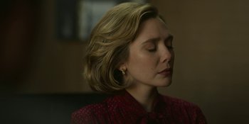 Movie still from “Love & Death” (2023), directed by Clark Johnson – A person with her eyes closed; Close Up shot, Low angle