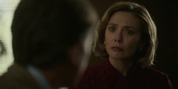 Movie still from “Love & Death” (2023), directed by Clark Johnson – A woman in a red shirt looking at a man in a red shirt; Close Up shot, Over the shoulder angle