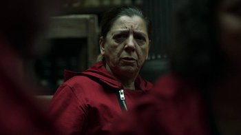 Movie still from “Money Heist” (2017), created by Álex Pina – An older woman in a red hooded sweatshirt; Close Up shot, Over the shoulder angle
