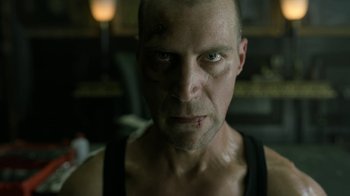 Movie still from “Money Heist” (2017), created by Álex Pina – A person with a black tank top on; Close Up shot, Low angle