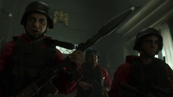 Movie still from “Money Heist” (2017), created by Álex Pina – A group of men in red and black uniforms holding guns; Medium shot, Low angle