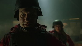 Movie still from “Money Heist” (2017), created by Álex Pina – A man and a woman wearing helmets in the dark; Close Up shot, Low angle